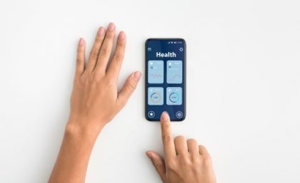 Hands with a smart phone showing health apps.